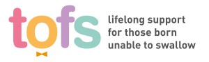 Colourful letters 't', 'o', 'f', 's' in pink, orange, purple, and teal, with the tagline 'lifelong support for those born unable to swallow' in grey.